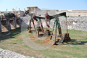 Cuba, Habana, the fortress, the moat, old oil rigs.