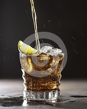 Cuba Libre with brown rum, cola, mint and lime. Cold Longdrink, alcohol cocktail. Place for text