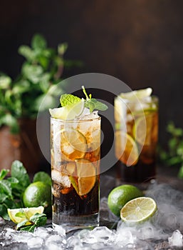 Cuba Libre with brown rum, cola, mint and lime. Cuba Libre or long island iced tea cocktail with strong drinks photo