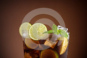 Cuba Libre cocktail. Alcoholic drink with cola, rum, lime and mint. Cuba Libre or long island iced tea cocktail.