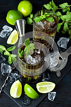 Cuba libre cocktail with rum, cola and lime, holidays party concept.