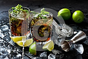 Cuba libre cocktail with rum, cola and lime, holidays party concept.