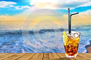 Cuba libre exotic tasty cocktail with beautiful sunset background