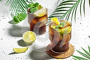 Cuba Libre or long island iced cocktail on a light background, cookbook recipe top view