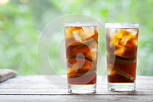 Cuba Libre or long island iced tea cocktail with strong drinks, cola, lime and ice in glass, cold longdrink or lemonade