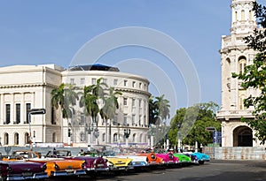 Cuba many classic cars parked in series in Havana with Capitol view