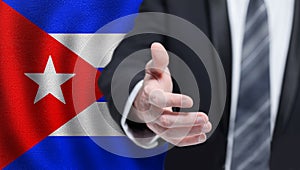 Cuba politics, cooperation and travel concept. Hand on Cuban flag background