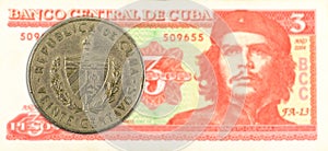 20 cuban centavo coin against 3 cuban peso banknote photo