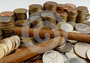 Cuban cigars with coins isolated on white