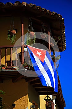 The Cuban flag on the second floor balcony of the building. Trinidad city, Cuba