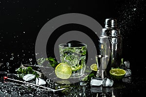 Cuban national drink. Glass of fresh mojito with splashes on dark background. Freeze motion, drops in liquid splash. haker,