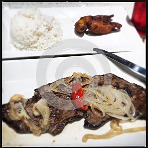 Cuban palomilla steak and rice photo
