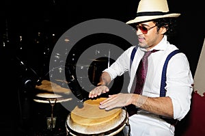 Cuban percussionist on black