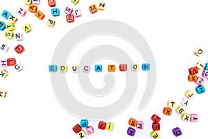 Cube beads collate in the word EDUCATION