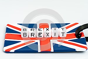 Cube block with alphabets building the word BREXIT on union jack UK flag travel luckage label with white copy space background