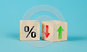 Cube block with percentage symbol icon. Interest rate financial and mortgage rates concept. Wood cube change arrow down