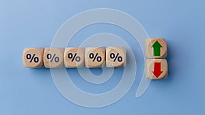 Cube block with percentage symbol icon. Interest rate financial and mortgage rates concept. Wood cube change arrow down to up.