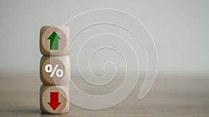 Cube block with percentage symbol icon. Interest rate financial and mortgage rates concept. Wood cube change arrow down to up.