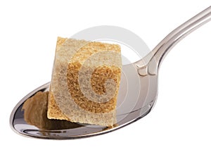 Cube of brown sugar on spoon