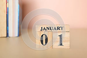 Cube calendar with date January 1st and books on the table.start new year 2024