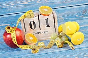 Cube calendar, fruits, dumbbells and tape measure, new years resolutions