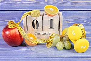 Cube calendar, fruits, dumbbells and tape measure, new years resolutions