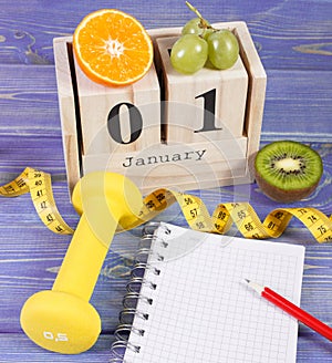 Cube calendar, fruits, dumbbells and tape measure, new years resolutions