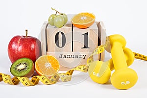 Cube calendar, fruits, dumbbells and tape measure, new years resolutions