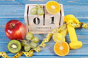 Cube calendar, fruits, dumbbells and tape measure, new years resolutions