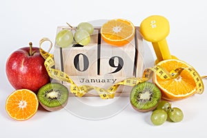 Cube calendar, fruits, dumbbells and tape measure, new years resolutions