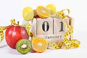 Cube calendar, fruits, dumbbells and tape measure, new years resolutions