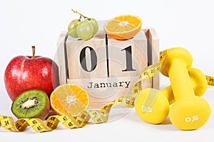 Cube calendar, fruits, dumbbells and tape measure, new years resolutions