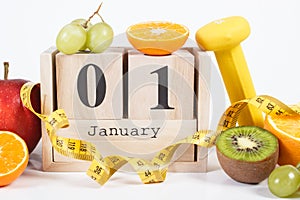 Cube calendar, fruits, dumbbells and tape measure, new years resolutions