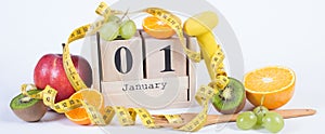 Cube calendar, fruits, dumbbells and tape measure, new years resolutions