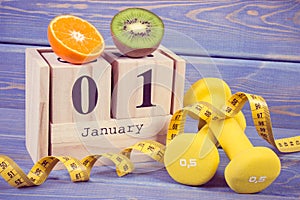 Cube calendar, fruits, dumbbells and tape measure, new years resolutions