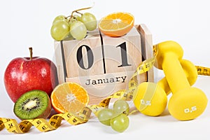 Cube calendar, ripe fruits, dumbbells and tape measure, new years resolutions