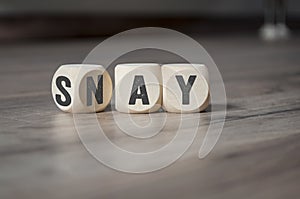 Cube and dice on wooden background with say and nay