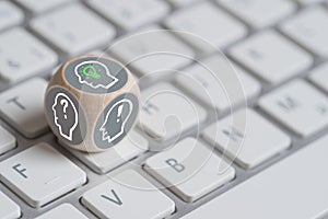 Cube with head sybols, on top one having an idea