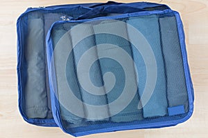 Cube meshed bags with rolled clothes. Set of travel organizer to help packing well organized