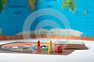 A cube with numbers and chips for a board game.