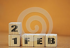 Cube shape calendar for february 21 on wooden surface with empty space for text, new year Wooden calendar with date, February cube