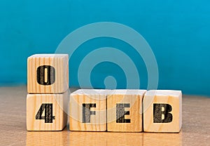 Cube shape calendar for February 04 on wooden surface with empty space for text,cube calendar for december on wood background