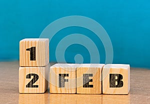 Cube shape calendar for February 12 on wooden surface with empty space for text,cube calendar for december on wood background