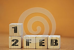 Cube shape calendar for february 12 on wooden surface with empty space for text, new year Wooden calendar with date, February cube