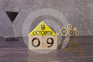 Cube shape calendar for October 09 on wooden surface with empty space for text