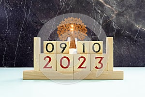 Cube shape calendar for October 09 on wooden surface with empty space for text