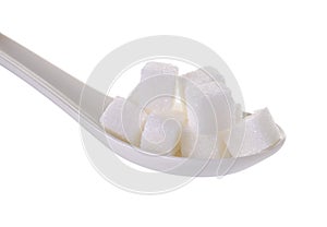 Cube sugars in teaspoon on white background