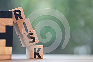 Cube wooden block with alphabet building the word RISK. Risk assessment