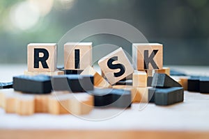 Cube wooden block with alphabet building the word RISK. Risk assessment