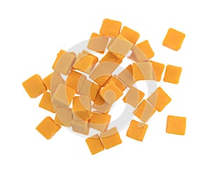 Cubed mild cheddar cheese on a white background